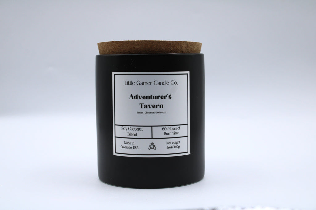 Black candle with a cork lid and label on a white background