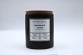 Black candle with a cork lid and label on a white background