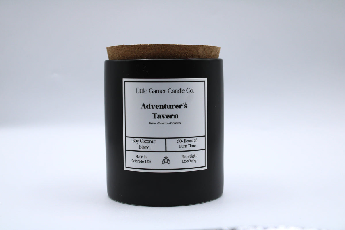 Black candle with a cork lid and label on a white background