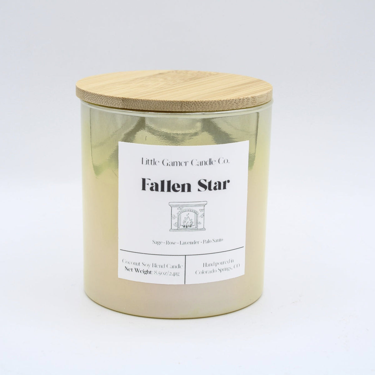 A yellow iridescent jar with a white label reading "Little Gamer Candle Co. Fallen Star" with a light bamboo lid on a white background.