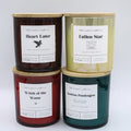 Four 8.5oz scented candles in cylindrical glass jars with bamboo lids, arranged in a 2x2 grid.