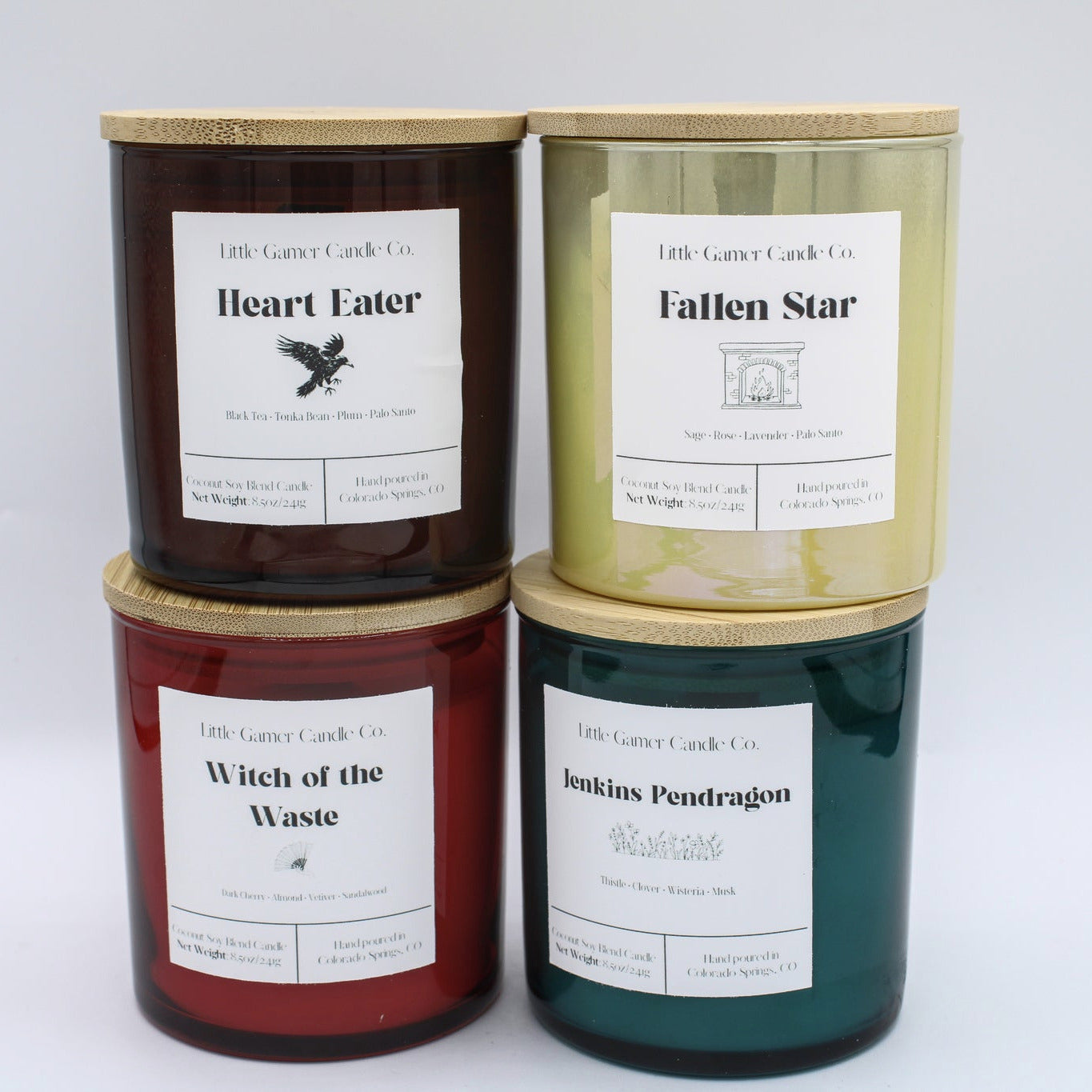 Four 8.5oz scented candles in cylindrical glass jars with bamboo lids, arranged in a 2x2 grid.