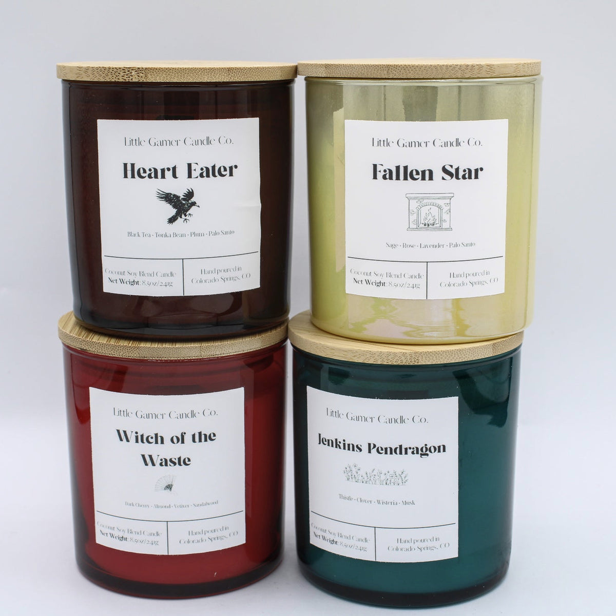 Four 8.5oz scented candles in cylindrical glass jars with bamboo lids, arranged in a 2x2 grid.